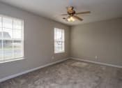 Thumbnail 20 of 26 - a bedroom with two windows and a ceiling fan