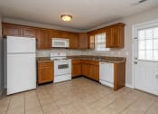 Thumbnail 26 of 26 - a kitchen with wooden cabinets and white appliances