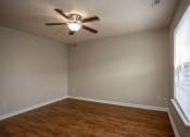 Thumbnail 19 of 26 - an empty room with a ceiling fan and a large window