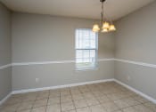 Thumbnail 21 of 26 - an empty dining room with a chandelier