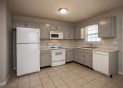 Thumbnail 4 of 26 - a kitchen with white appliances and gray cabinets