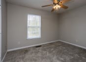 Thumbnail 22 of 26 - a bedroom with a ceiling fan and a window