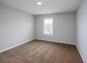 Thumbnail 9 of 25 - a bedroom with gray walls and a window