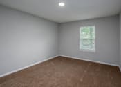 Thumbnail 12 of 25 - a bedroom with gray walls and a window