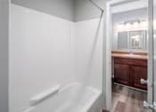 Thumbnail 11 of 25 - a bathroom with a bathtub and a sink