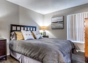 Thumbnail 12 of 34 - a bedroom with a bed and a dresser and a window at L'Estancia, Florida