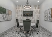 Thumbnail 6 of 50 - a conference room with a table and chairs and a television