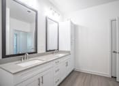 Thumbnail 26 of 50 - a white bathroom with two sinks and three mirrors