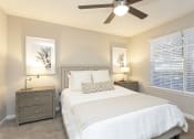Thumbnail 11 of 27 - a bedroom with a bed and a ceiling fan at Crestmont at Thornblade, Greenville