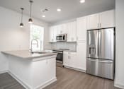 Thumbnail 18 of 50 - a kitchen with white cabinets and stainless steel appliances