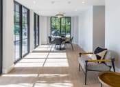 Thumbnail 8 of 22 - a seating area with chairs and a table in a room with large windows at Leena Plantation, Florida, 33322