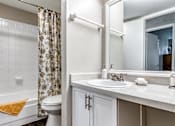 Thumbnail 17 of 32 - A white bathroom with a toilet, sink, and shower L'Estancia, Sarasota, FL, 34231