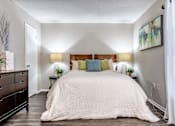 Thumbnail 13 of 32 - A bedroom with a large bed and a wooden dresser L'Estancia, Sarasota, FL, 34231