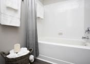 Thumbnail 20 of 27 - a bathroom with a bathtub and a basket of towels at Thornblade, Greenville, South Carolina