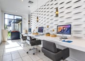 Thumbnail 7 of 35 - Luxury Apartments for Rent in Altamonte Springs, FL - Nine12 Gateway - Wifi Cafe with Spacious Workstations, Desktop Computers, Leather Office Chairs, Pendant Lights, and Large Floor-to-Ceiling Window.