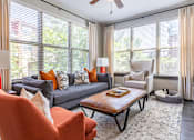 Thumbnail 8 of 46 - a living room with a couch and a coffee table