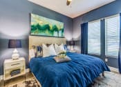 Thumbnail 21 of 35 - a bedroom with blue walls and a blue and white bed