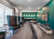 Thumbnail 21 of 32 - a restaurant with green walls and chairs and a bar with tables and chairs