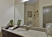 Thumbnail 29 of 36 - a bathroom with a sink and a large mirror
