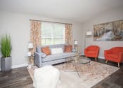 Thumbnail 10 of 16 - a living room with a couch and chairs and a window