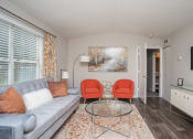 Thumbnail 11 of 16 - a living room with a couch and two chairs and a table