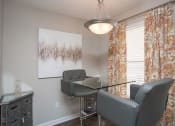 Thumbnail 7 of 16 - One-Bedroom Apartments in Atlanta, GA - City Park - Dining Area with Glass Table, Chandelier, and Large Window.
