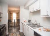 Thumbnail 4 of 16 - a kitchen with white cabinets and a stainless steel sink