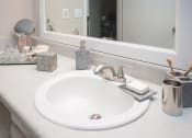 Thumbnail 13 of 16 - a bathroom with a sink and a mirror