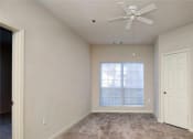 Thumbnail 20 of 30 - an empty bedroom with a ceiling fan and a window