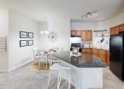 Thumbnail 10 of 31 - a kitchen with a bar and a dining table with chairs