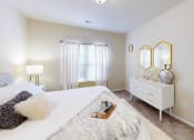 Thumbnail 16 of 31 - a bedroom with a bed and a dresser