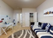 Thumbnail 19 of 31 - a bedroom with a bed and a desk and a closet