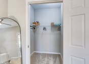 Thumbnail 10 of 29 - an empty closet with white walls and a white door