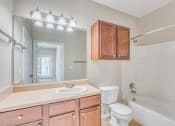 Thumbnail 15 of 29 - a bathroom with a sink toilet and a mirror
