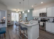 Thumbnail 2 of 23 - a kitchen with an island and stools