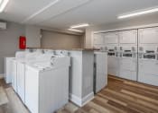 Thumbnail 18 of 25 - a laundry room with washers and dryers