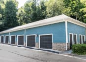 Thumbnail 37 of 38 - a blue building with a row of garage doors
