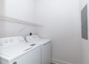 Thumbnail 6 of 38 - a white washer and dryer in a white laundry room with a shelf above