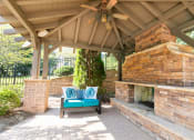 Thumbnail 23 of 38 - a patio with a bench and a gazebo