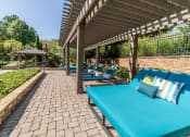 Thumbnail 24 of 38 - a patio with blue couches and chairs and a pavilion