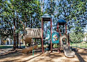 Thumbnail 21 of 30 - A playground with a slide, a roundabout, and a climbing frame.