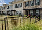 Thumbnail 63 of 65 - A row of houses with black fences in front.