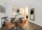 Thumbnail 13 of 30 - A dining room with a glass table and brown chairs.