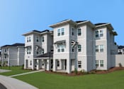 Thumbnail 66 of 67 - A row of modern houses with white exteriors and dark roofs.