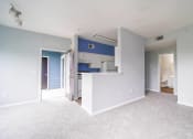 Thumbnail 16 of 31 - a empty living room with a blue and white kitchen