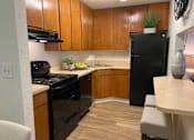 Thumbnail 3 of 21 - Sleek black appliances add a modern touch to the kitchen at Lake in the Woods, Melbourne