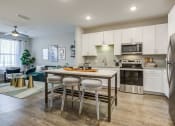 Thumbnail 13 of 22 - a kitchen with stainless steel appliances and a center island with three stools