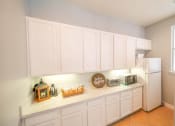Thumbnail 15 of 31 - a kitchen with white cabinets and a white refrigerator