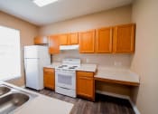Thumbnail 25 of 69 - full kitchen with white appliances and wooden cabinets