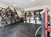 Thumbnail 18 of 41 - a room with many bikes hanging on a wall and a red door